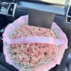 75 pink roses surrounded with a cloud of babys breath