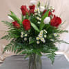 One dozen red roses with assorted white fillers