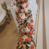 A dramatic long hanging main centerpiece that reads like a cascading floral
