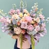 Pastel-packed and dreamy, this large floral arrangement brings a soft, romantic garden