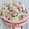 Soft clusters of pale pink spray roses nestled against voluminous white hydrangea