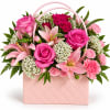 Pink roses and lilies in a pink quilted gift bag