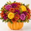 Mixed bouquet in a pumpkin-shaped orange container with roses and daisies