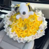 Yellow rose bouquet with a plush Snoopy topper and white flowers