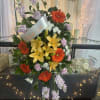 A bright, respectful standing spray that offers comfort with vivid color: this