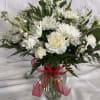 A cloud of white blooms-feathery chrysanthemums, ruffled carnations and sprigs of baby's