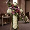 A standing floral cross crafted for sympathy and memorial services, this funeral