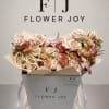 Bouquet of blush and cream roses in a white gift box