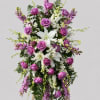 A tall, formal standing spray that reads as both comforting and graceful-perfect