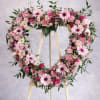 A lush heart-shaped wreath in soft pinks and whites, this funeral or