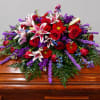 A broad, cascading casket spray made to convey deep respect and comfort