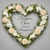 A heart-shaped arrangement in soft whites and fresh greens, designed to convey