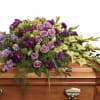 A sweeping display of lavender roses and pale green gladiolus, this casket