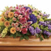 A large, full sympathy spray that reads like a garden of sweet