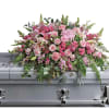 A lush cascade of soft pink roses and pale pink lilies creates