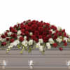 A dense mound of deep red roses and red carnations sweeps across