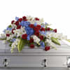 A bold tri-color display anchored by dense clusters of red roses, white