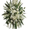 A tall, sculptural standing spray that reads with quiet dignity - perfect