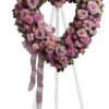 A heart-shaped standing wreath crafted in soft pinks, lavenders and clean whites-designed