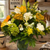Sunny yellow focal flowers and creamy white lilies and carnations come together