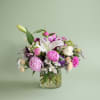 True peonies, elegant lilies, roses, and premium seasonal blooms gathered into a