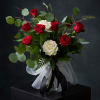 roughly 9&ndash;12 premium roses, premium greens, styling, ribbon treatment, vase/container A romantic