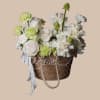 Soft pale tones and a gentle, rounded silhouette make this flower arrangement