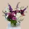 White, lavender, and dark purple florals form the heart of this garden-style