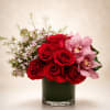 A romantic luxury floral arrangement featuring premium red roses paired with soft