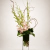 An elegant high-style floral arrangement featuring graceful blush dendrobium orchids designed with