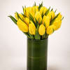 A radiant arrangement of vibrant yellow tulips artfully gathered in a sleek