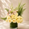 A refined and luxurious floral arrangement featuring creamy ivory roses, delicate blush