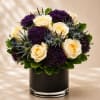 A bold and sophisticated floral arrangement featuring creamy ivory roses paired with