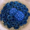 A breathtaking bouquet featuring rich dark-blue roses arranged tightly around two vibrant