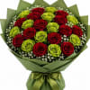 Bouquet of red and green roses wrapped in green paper with a ribbon.