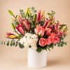 Pink roses, lilies, and carnations in a white vase