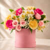 Pink and yellow mixed bouquet in a round pink box