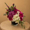 Pink and white mixed flower arrangement in a clear glass vase