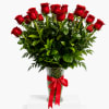 Red roses in a clear vase tied with a red ribbon