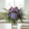 Purple and lavender bouquet in a clear glass vase
