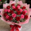 A lush cluster of red and pink roses makes an immediate romantic