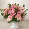 Soft pink roses and lilies take center stage in this Garden of