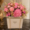 Soft pink roses and a plush dome of pink hydrangeas create a