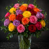 Bouquet of multicolored roses in a clear glass vase