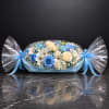 Blue and white flower arrangement wrapped like a candy with ribbon bows