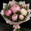 Pink and white peony bouquet wrapped in pale pink paper