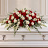 Red and white rose casket spray with eucalyptus and white filler flowers
