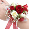 Red and white rose wrist corsage with ribbon accents