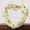 Heart-shaped white floral wreath with lavender ribbons