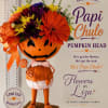 Pumpkin-headed figure topped with colorful flowers and an orange ribbon bow